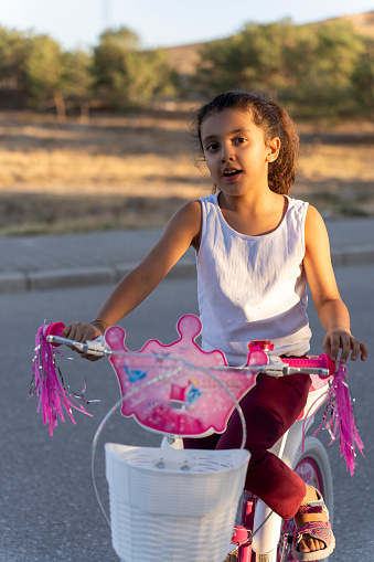 A girl riding a bicycle.