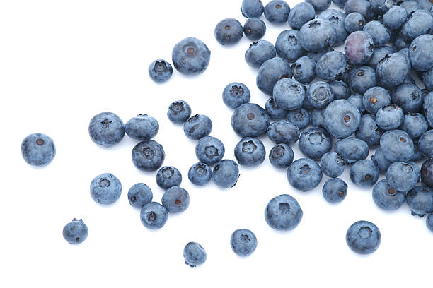 Blueberries scattered on white background Scattered blueberries over white background. blueberry stock pictures, royalty-free photos & images