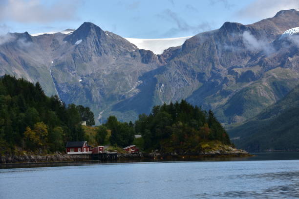 istock A big mountain back to a forest with a red house, in Norway 1828681607