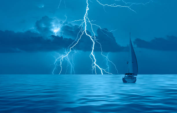 istock Sailing yacht in a stormy weather with thunder and lightning 1828691939