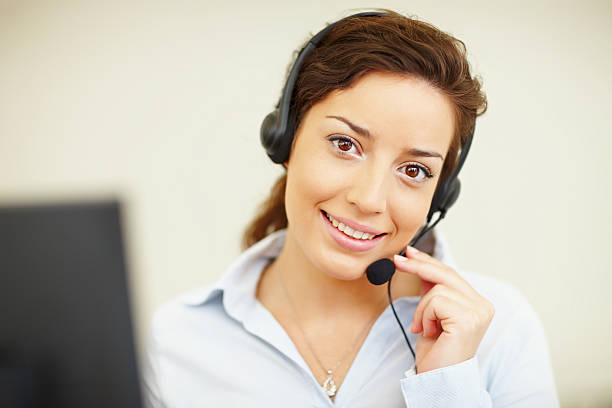 istock Smiling call center employee wearing a headset 182869488