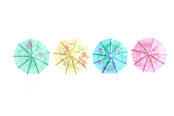 Cocktail umbrellas 4 party cocktail umbrellas, green, yellow, blue, pink isolated on white, top view drink umbrella stock pictures, royalty-free photos & images