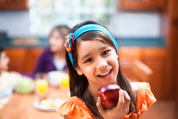 istock Cute little girl holding an apple 182869738