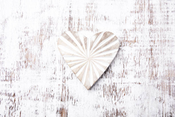 Wooden Heart (Christmas ornament) on bright background. Top view. Close up.