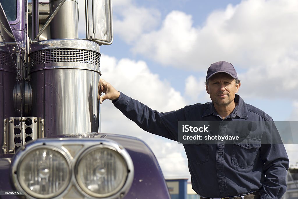 Trucker and Chrome A truck driver stands next to his rig. Truck Driver Stock Photo