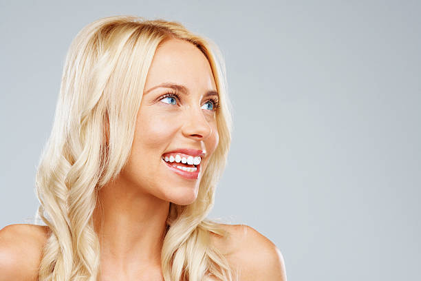 istock Happy young woman looking up at copy space 182870069