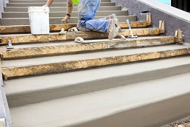 Photo of Concrete Worker Troweling New Steps