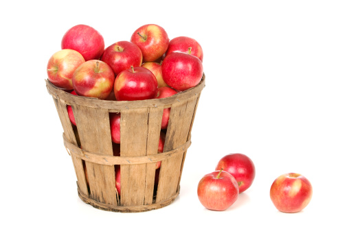 A fresh picked basket of ripe red apples.