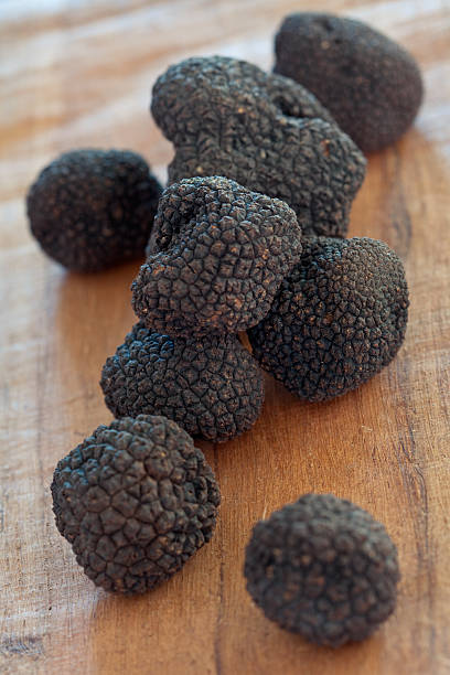 istock Rare sweet black truffles on a wooden table 182871435