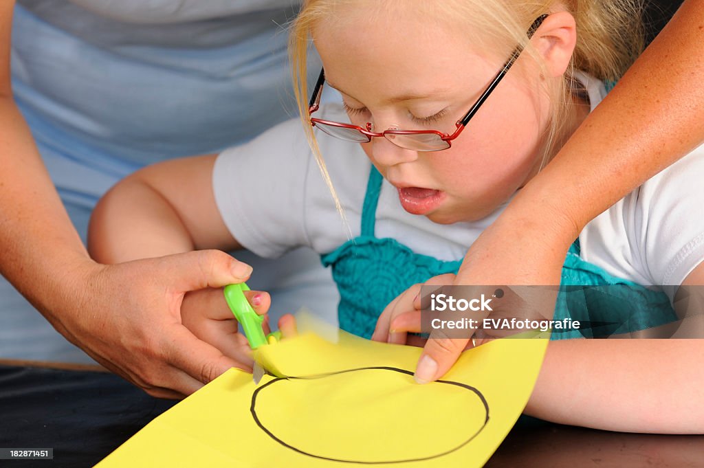 Handicapé fille est à l'aide de ciseaux - Photo de Ciseaux libre de droits