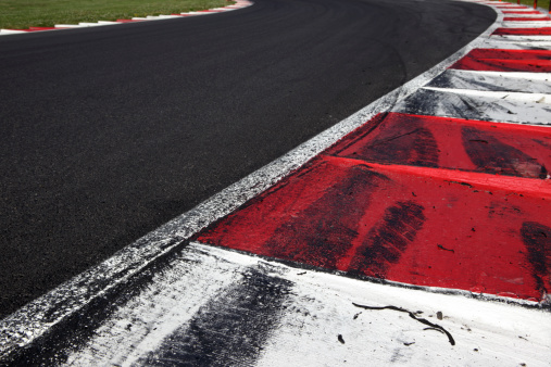 FIA style Kerb (curb) on a motorsports race track showing skid marks from cars going off the track.