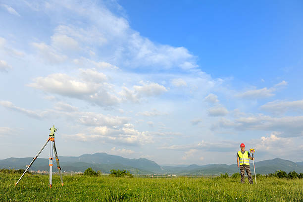 Land surveyor working with total-station in nature lots of copy space. 