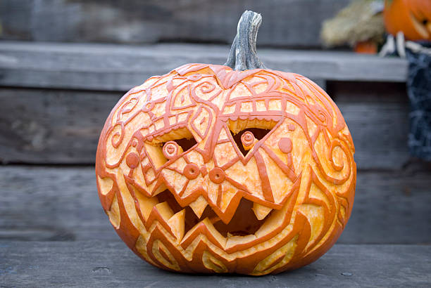 Halloween Pumpkin: Carved Jack o' Lantern Autumn Decoration & Front Porch Halloween pumpkin: Autumn carved jack-o-lantern decoration on house front porch. (SEE LIGHTBOXES BELOW for more holiday backgrounds...) halloween pumpkin decorations stock pictures, royalty-free photos & images
