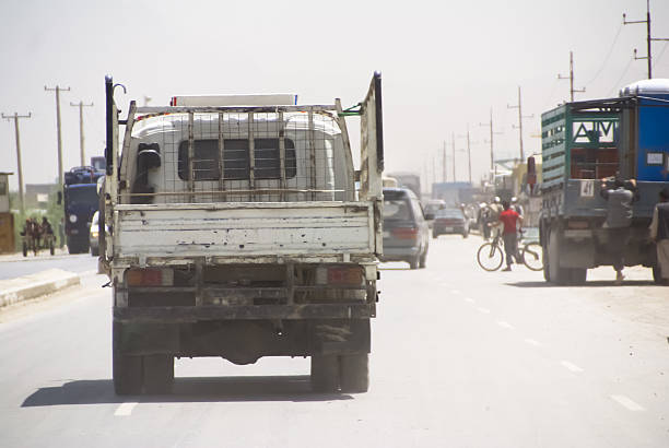 Two cargo trucks transit a road in the Salinas Grandes in Jujuy, Argentina