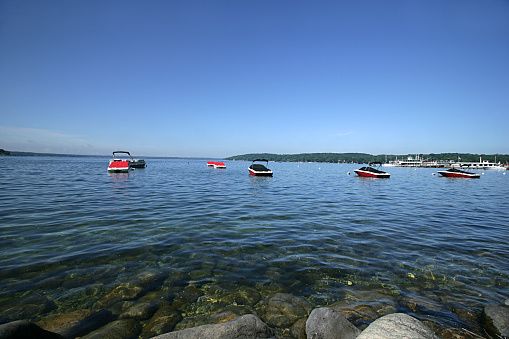 Several speedboats dock on the waters of Lake Geneva