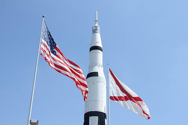 American Space Travel "The Saturn V on display in Huntsville, Alabama with the Alabama flag and the United States flag." huntsville alabama stock pictures, royalty-free photos & images