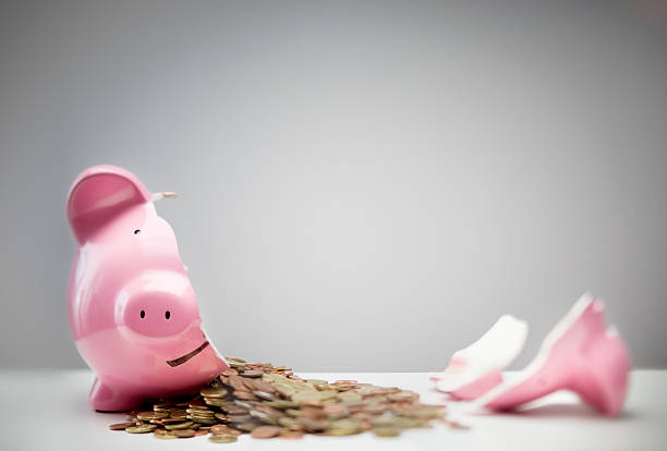Broken Piggy Bank Money coming out of a broken piggy bank breaking stock pictures, royalty-free photos & images