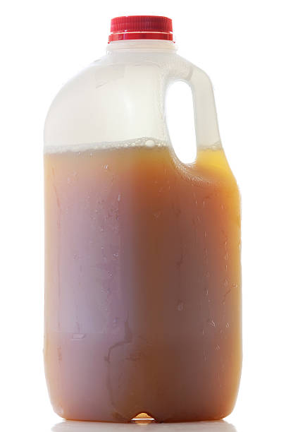 Jug of Apple Cider A single plastic jug of Apple Cider isolated on white. apple juice photos stock pictures, royalty-free photos & images