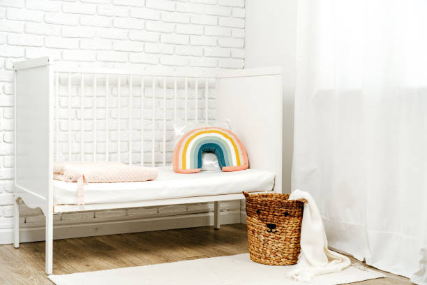 istock Kid's room interior with comfortable bed and rainbow pillow 1828752731