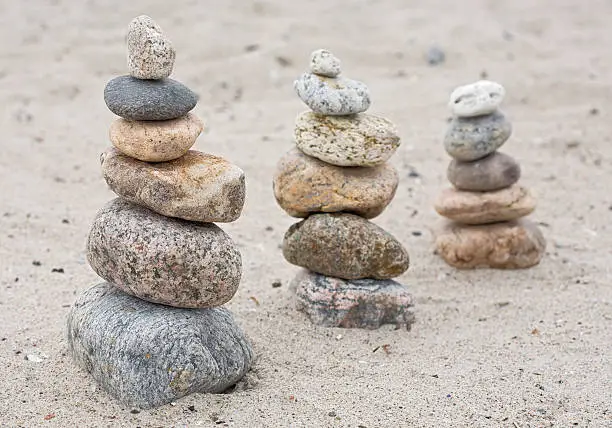 "three heaps of pebbles on the beach,"
