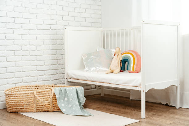 istock Kid's room interior with comfortable bed and rainbow pillow 1828759828