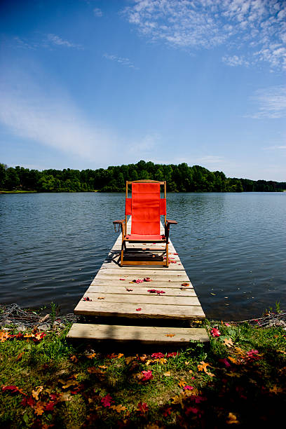istock Red Chair on a lake with blue sky 182876028