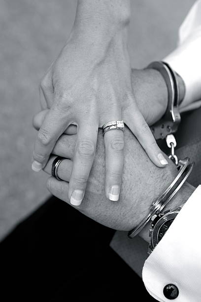 istock Bride's Hand Holding Groom's Handcuffed Hands 182876315