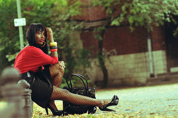 Depressed beautiful ethnic woman sitting at a park - shallow dof