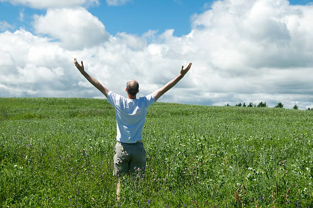 istock Man in the field asking for good weather 182877291