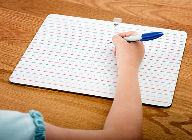 School Work Back to school with a dry erase board. No need to waste paper when working on spelling words. The dry erase board is an economical and earth friendly way to go! kids using smart board stock pictures, royalty-free photos & images