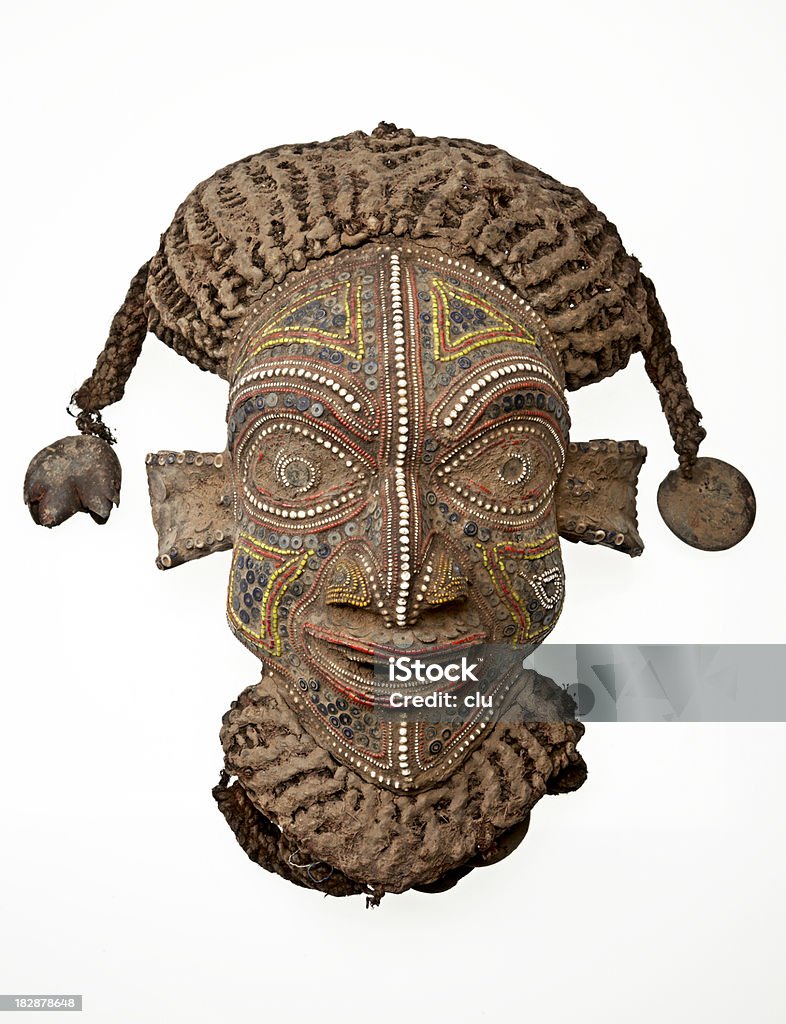 African mask isolated on white background Studio shot. Vertical format. White background. Mask - Disguise Stock Photo