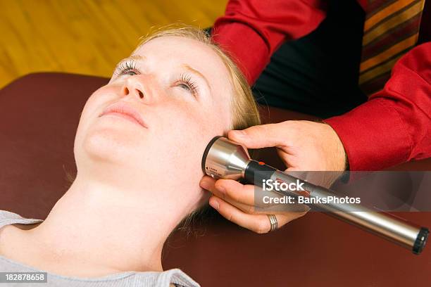 Doctor Administering Cold Laser Therapy Treatment To Female Patients Face Stock Photo - Download Image Now