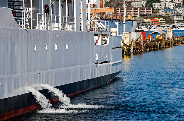 Ship discharging ballast water into lake Research vessel discharging ballast water into lake ballast water stock pictures, royalty-free photos & images