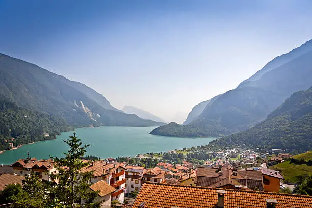 The Molveno lake with the alpine village of Molveno. The location is the Dolomiti del Brenta (Trentino-Alto Adige, Italy) during the summer season.