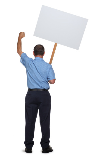 Striking or protesting blue collar worker with fist raised and back turned towards camera holding a blank sign. To see more blue collar workers click on the link below: