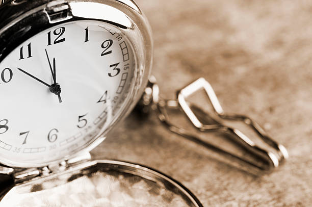 istock Clock face of open silver pocket watch with chain 182879282
