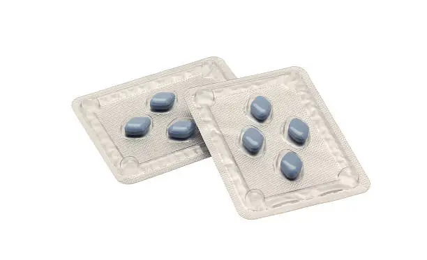 Two blister packs of blue Viagra anti-impotence tablets isolated on a white background