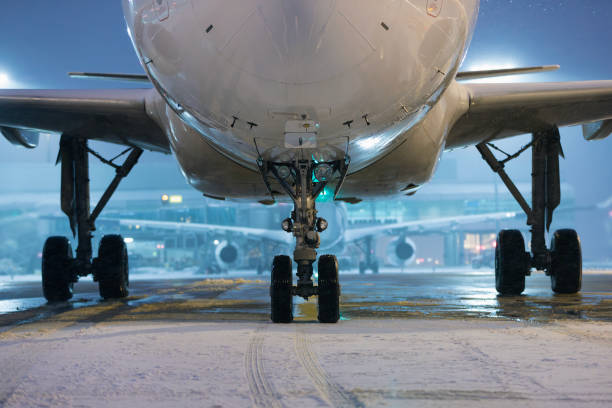 istock Winter frosty night at airport during snowfall 1828795427