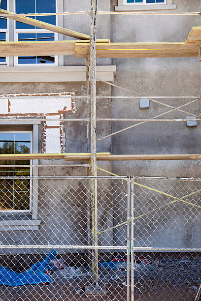 istock Chainlink fence on new house construction 182879792