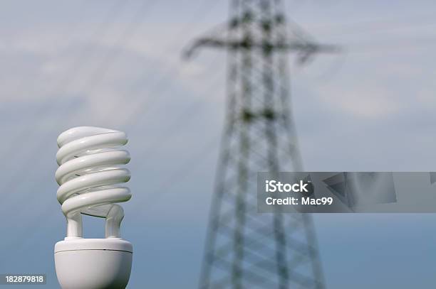 Energy Saving Lamp With Powerline In Background Stock Photo - Download Image Now - Agricultural Field, Blue, Bright