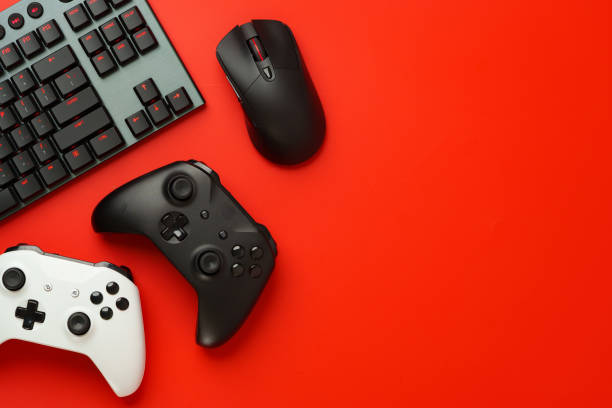 istock Gamer equipment on red background top view 1828802772