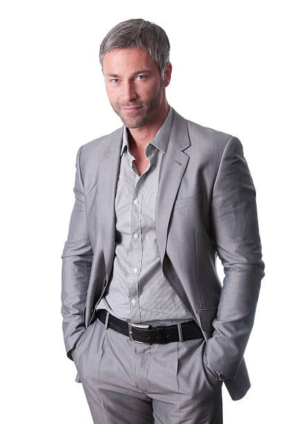 Smiling businessman posing with hands in pockets