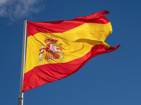3d waving Catalunya pro-independence flag a  traditional design with  four red stripes over a yellow field with a blue triangle at the hoist containing a five-pointed white star