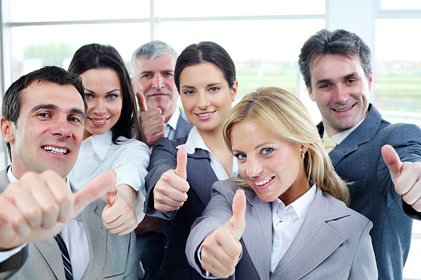 istock Smiling business team shows ok. 182881546