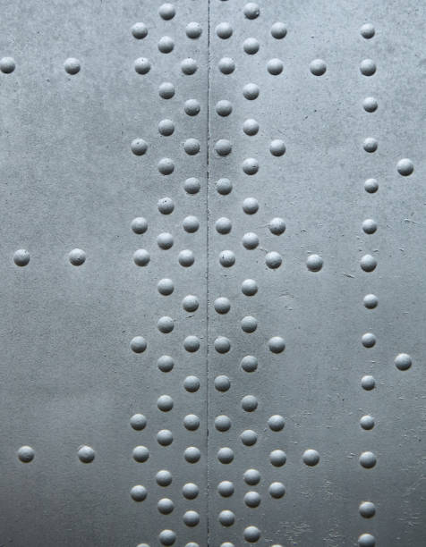 istock The texture of an old metal painted surface with rivets. 1828815556