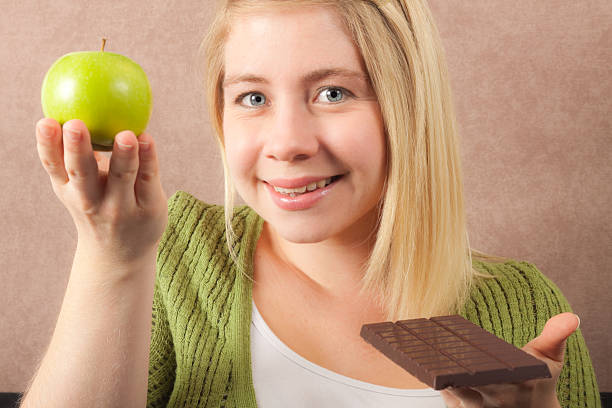 istock Woman Chosing an Apple over Chocolate 182882104