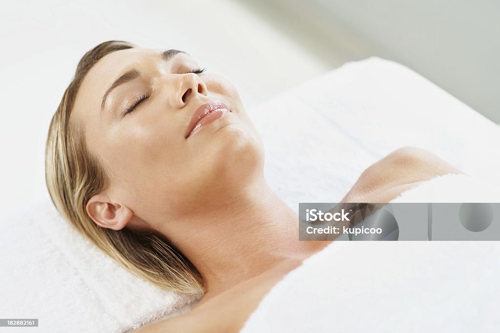 Relaxed young female with eyes closed lying at spa Close-up of a relaxed young lady with eyes closed lying at spa 30-34 Years Stock Photo