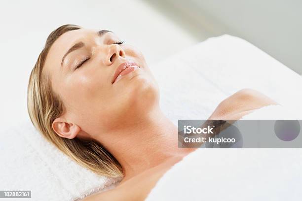 Relaxed Young Female With Eyes Closed Lying At Spa Stock Photo - Download Image Now - 30-34 Years, 30-39 Years, Adult