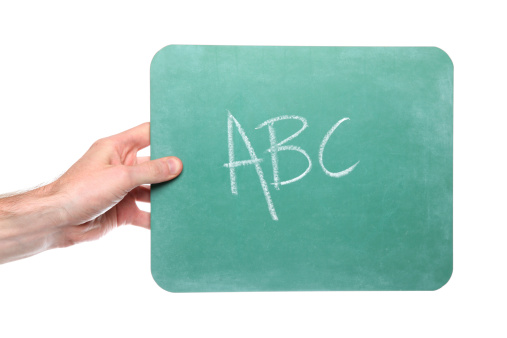 Male hands holding isolated chalkboard with ABC written on