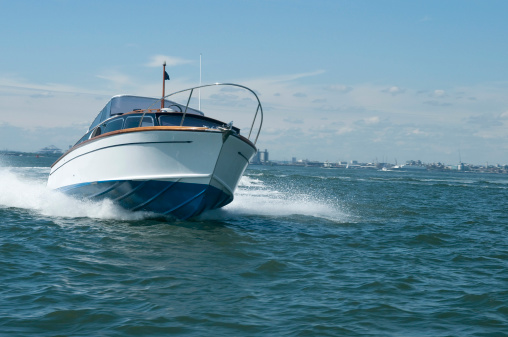 A superb classic british motor boat at speed in Southampton Water on the South Coast of the UK.
